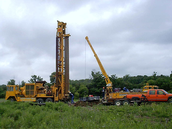 Set up and plumb rig over existing well